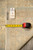 Reverse of the rug with tape measure, stock tag numbered 77571 and handwritten size marking