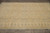 Horizontal overhead shot of the 8x11 Ziegler Chobi wool rug on grey tile floor