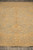 Pakistani hand-knotted Chobi rug seen lengthwise with ivory fringe and wide tan gold border