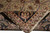 Folded corner reveals dense hand-knotted back, tight weave and cream cotton fringe of wool rug