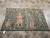 4' x 6'3" antique French tapestry laid flat on stone tile floor showing full medieval scene