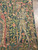 Armored knight with cross banner framed by pink roses and green foliage in tapestry corner