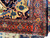Rust main border with diamond rosettes and guard stripes on 1900s Persian village rug