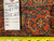 Back tag reading Genuine Hand Woven Oriental Rug number 6497 beside a tape measure
