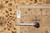 Back of the rug with hand woven Oriental rug tag and tape measure for scale