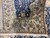 Back of the rug folded over, showing tight even weave and crisp pattern definition