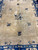 9x12 Chinese Art Deco rug field detail with central flower vase and four corner urns