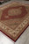 Angled floor view of the 8 x 10 rug highlighting silk sheen across the ruby red pile