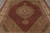 Overhead angle showing layered diamond medallion, fish pattern field and tan green corner spandrels