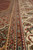 Ivory main border and guard stripes with palmettes, vines and zigzag bands in raking light