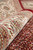 Rolled edge showing ivory border palmettes, plush pile depth and the firm selvage of this rug