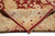 Folded corner revealing dense hand-knotted wool pile, ivory border reverse and natural cotton fringe