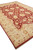 10 x 14.8 hand-knotted Pakistani Ziegler rug angled to show fringed end and gold blossoms