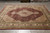 8'2 x 10 hand-knotted wool and silk rug displayed flat on grey tile showroom floor