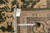 Back of the rug with tape measure and tag confirming size and hand-knotted construction