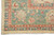 Corner of the green main border with ivory palmettes, coral vinework and natural ivory fringe