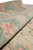 Rolled edge of the rug revealing dense wool pile, low even height and soft handle