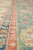 Macro of border stripes in coral, indigo blue and green wool on an Oriental rug