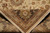 Folded corner detail revealing dense natural wool pile, border rosette and the clean woven back