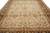 Close top view of the beige field with rust and sage floral sprays framed by brown