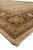 Side angle of the 10 by 14 Indian rug corner showing fringe, guard stripes and border