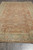 8x16 gallery size Oriental rug shown at an angle with all-over floral field and ivory fringe