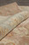 Rolled pile showing wool depth, quiet sheen and the pale rust reverse of the weaving