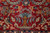 Hand-knotted flowering tree and vase motif in blue and gold against deep madder red wool pile