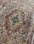 Overhead detail of the 10x14 Tabriz medallion and dense floral vinework in soft neutral tones