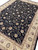 8'6" x 11'6" Chinese Oriental rug angled on floor showing beige border and black field