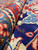Rolled edge of the rug revealing dense wool pile depth and tight knot structure