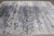 Silver gray abstract field on showroom floor with slate blue mottled pattern flowing across pile