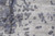 Close-up of lustrous silk highlights and taupe shading within the abstract gray erosion pattern