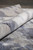 Rolled edge revealing plush wool and silk pile depth and the tight hand-knotted weave