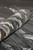 Rolled edge of the gray modern rug showing plush wool and silk pile depth and finished selvage