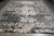 Angled showroom view of the 9'11" x 13'9" hand-knotted Indian rug with ivory damask fragments