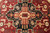 Central stepped medallion in black and ivory with apricot cypress motifs on burgundy ground