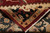 Back of the rug folded over, showing even hand-knotting, white fringe and tight wool weave