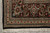 Corner detail of ivory guard borders with rose palmettes, black main border and clean fringe