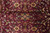 Detail of plum maroon ground with 8 petal rosettes, leaf sprays and fine vine tracery