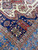 Close view of navy inner border, red zigzag panel and green 8 point star motif