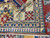 Folded corner revealing dense hand-knotted weave, ivory ground border and blue diamond minor bands