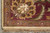 Corner detail of the 9'10" x 14' rug with gold palmette and cotton fringe