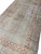 Close angled view of muted sage field, blush main border and brown cloud band scrolls