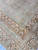 Border corner showing three band layout, candelabra motifs and geometric fillers in blush and brown