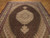 6'6" x 9'11" Tabriz rug on parquet floor showing ivory medallion and herati field