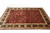 Low angle view of the black main border with gold palmette cartouches and ivory guard stripes
