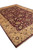 Corner angle of the 10x14 Indian hand-knotted rug showing gold border and maroon pile