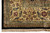 Corner detail showing gold ivory border, green guard stripes, red rosettes and black outer edge