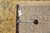 Back of the 9'8" x 13'8" Kashan rug with tape measure and inventory tag F-4304